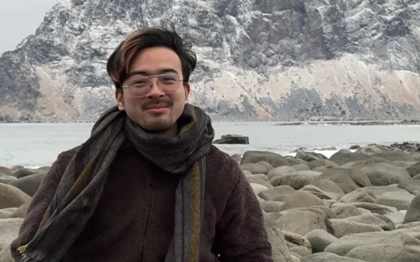 Xiaoyao Guo in a medium close up in front of an icy mountain