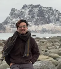 Xiaoyao Guo in a medium close up in front of an icy mountain